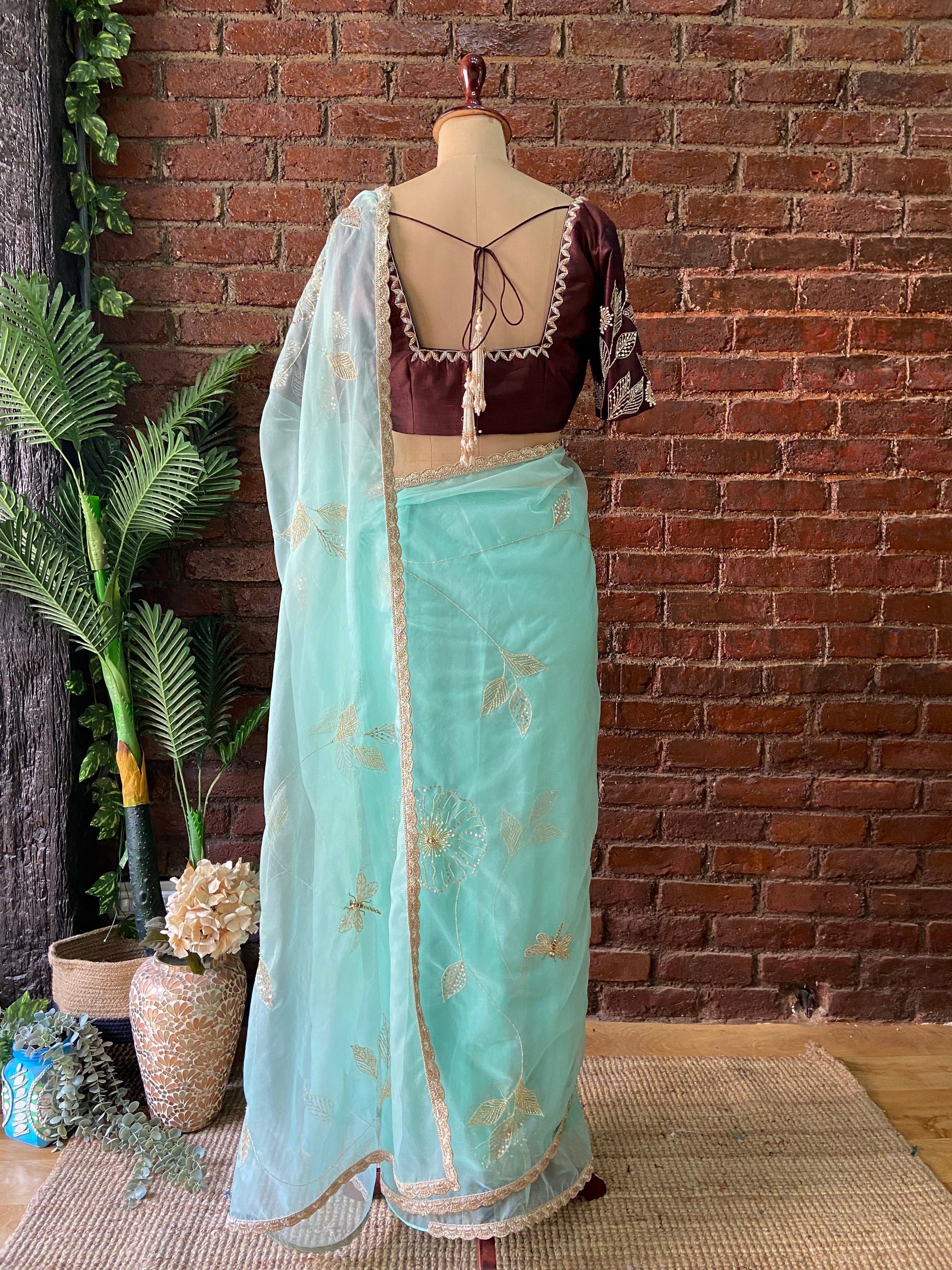 Ice Blue Organza Embroidered Saree  - Traditional outfit with a brown blouse and light blue saree