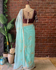 Ice Blue Organza Embroidered Saree - Traditional outfit with a brown blouse and light blue saree