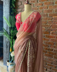 Burnt Burgundy Organza Embroidered Saree. Saree with pink blouse on a mannequin.