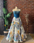 Off White and Blue Corset Lehenga Set. Mannequin wearing a blue top and floral skirt.