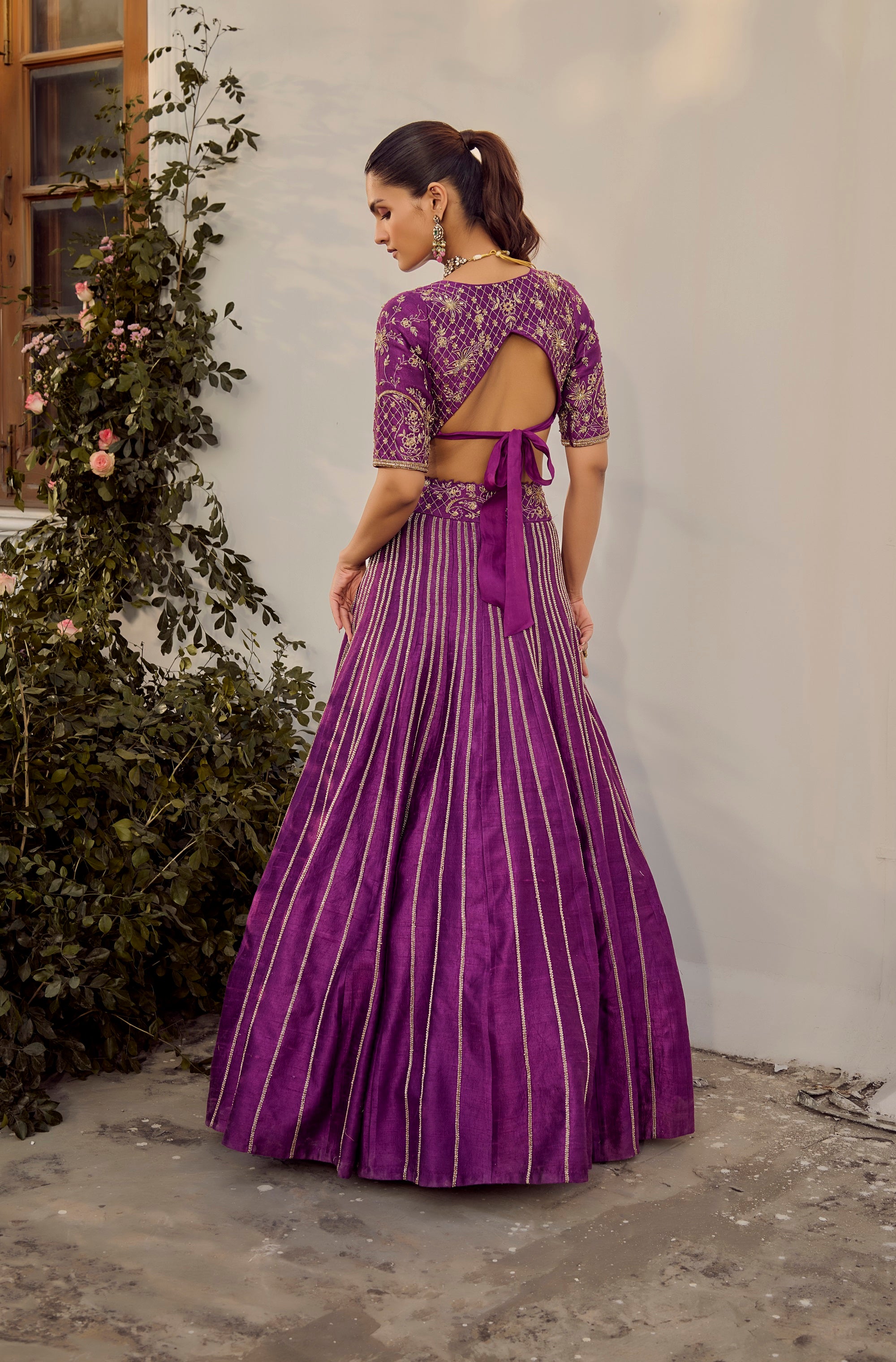 Soft Mulberry Lehenga Set. Woman wearing a purple traditional outfit.